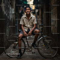 Smiling Boy Sitting on a Bicycle in Urban Alley