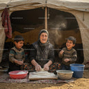 Family Baking Bread Outdoors in Rural Tent Setting