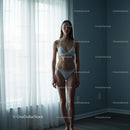 Serene Woman in White Lingerie by a Sunlit Window
