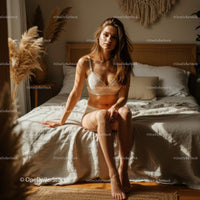 Woman Relaxing in Sunlit Bedroom
