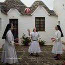 Nuns Playing with Ball in Sunny Courtyard