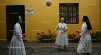 Nuns Enjoying Leisure Time in a Sunny Courtyard