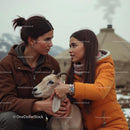 Family Bonding with Goat in Rustic Mountain Setting