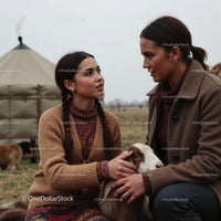 Women Engaged in Conversation with Goat in Countryside