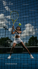 Female Tennis Player in Action on Sunny Outdoor Court