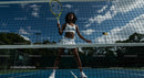 Female Tennis Player in Action on Sunny Court