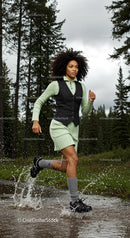 Woman Running Through a Forest Trail with Energetic Splash