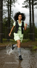 Woman Running Through a Forest Trail with Energetic Splash