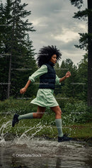 Woman Running Through Forest in Green Dress