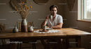 Man Enjoying Coffee at a Rustic Wooden Table