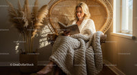 Woman Reading in Sunlit Bohemian Chair with Knit Blanket