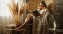 Woman Relaxing with a Book in a Cozy Bohemian Setup
