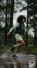 Woman Running Through a Forest Trail with Energetic Splash