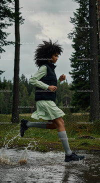 Woman Running Through Forest Splashing in Water