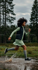 Woman Running Through a Forest Trail with Energetic Splash