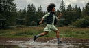 Woman Running Through Forest Puddle in Green Dress