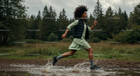 Woman Running Through Forest Puddle in Green Dress