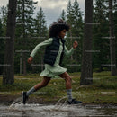 Energetic Woman Running Through Forest Trail