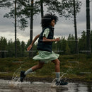 Woman Running Through Forest in Green Dress with Water Splashing