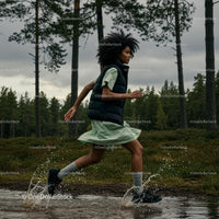 Woman Running Through Forest in Green Dress with Water Splashing