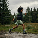 Woman Running Through a Forest Trail with Energetic Splash