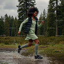 Woman Running Through a Forest Trail with Energetic Splash