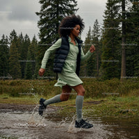 Woman Running Through a Forest Trail with Energetic Splash