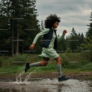 Woman Running Through a Forest Trail with Energetic Splash