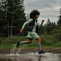 Woman Running Through a Forest Trail with Energetic Splash
