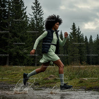 Woman Running Through a Forest Trail with Energetic Splash