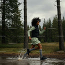 Woman Running Through Forest Trail Splashing Water