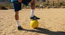 Desert Soccer Scene with Yellow Ball and Players
