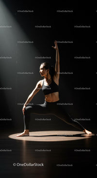 Woman Practicing Yoga Pose in Dramatic Spotlight