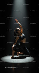 Graceful Dancer Strikes Dynamic Pose Under Spotlight