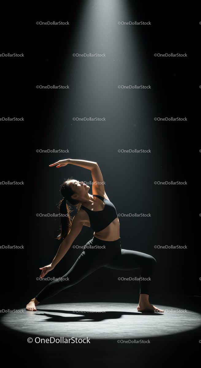 Graceful Yoga Pose Under Spotlight in Studio