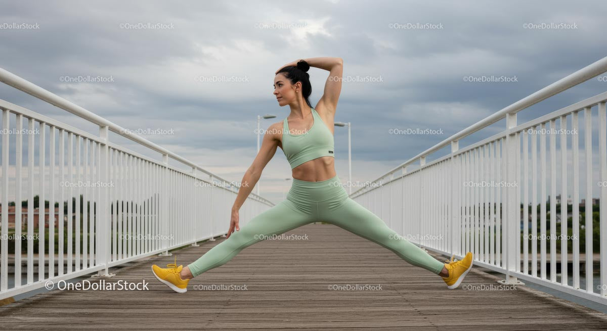 Woman Performing Yoga on Bridge in Sky Blue Sportswear