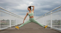 Woman Performing Yoga on Bridge in Sky Blue Sportswear