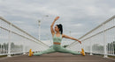 Woman Performing Yoga Split on Outdoor Bridge