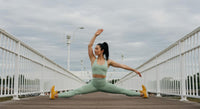 Woman Performing Yoga Split on Outdoor Bridge