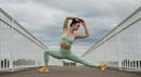 Woman Practicing Yoga on a Bridge in Mint Green Outfit