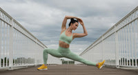 Woman Practicing Yoga on a Bridge in Mint Green Outfit