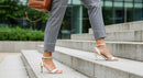 Stylish Woman in White Heels Climbing City Stairs