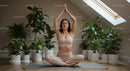 Woman Practicing Yoga Amidst Lush Indoor Greenery