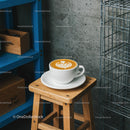 Latte Art Coffee on Wooden Stool in Industrial Cafe Corner