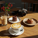 Cozy Café Setting with Latte Art and Pastries