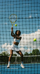 Female Tennis Player in Action at Sunny Outdoor Court