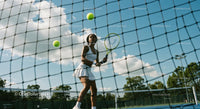 Woman Playing Tennis on a Sunny Outdoor Court