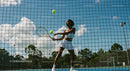 Female Tennis Player Practicing Under Clear Blue Sky