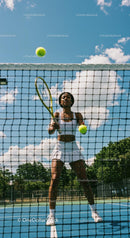Female Tennis Player in Action at Sunny Outdoor Court