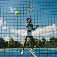Female Tennis Player in Action on Outdoor Court